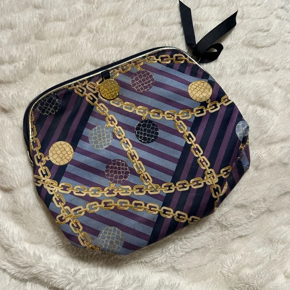 Estée Lauder purple, blue, and gold chain-print cosmetic bag.